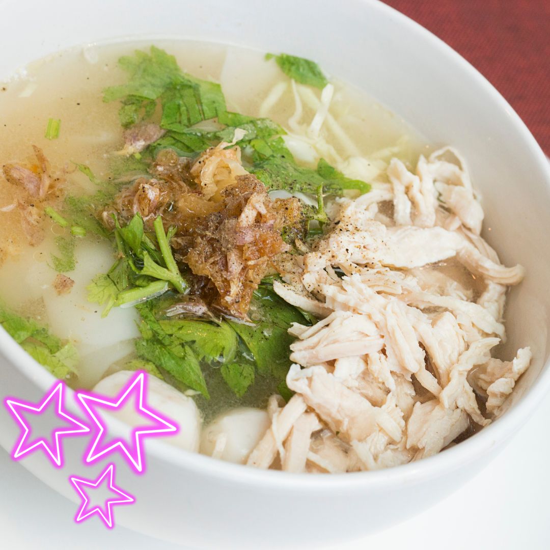 A comforting bowl of soup with shredded chicken, fresh herbs, and crispy fried onions, showcasing a flavorful and nourishing dish perfect for any meal.
